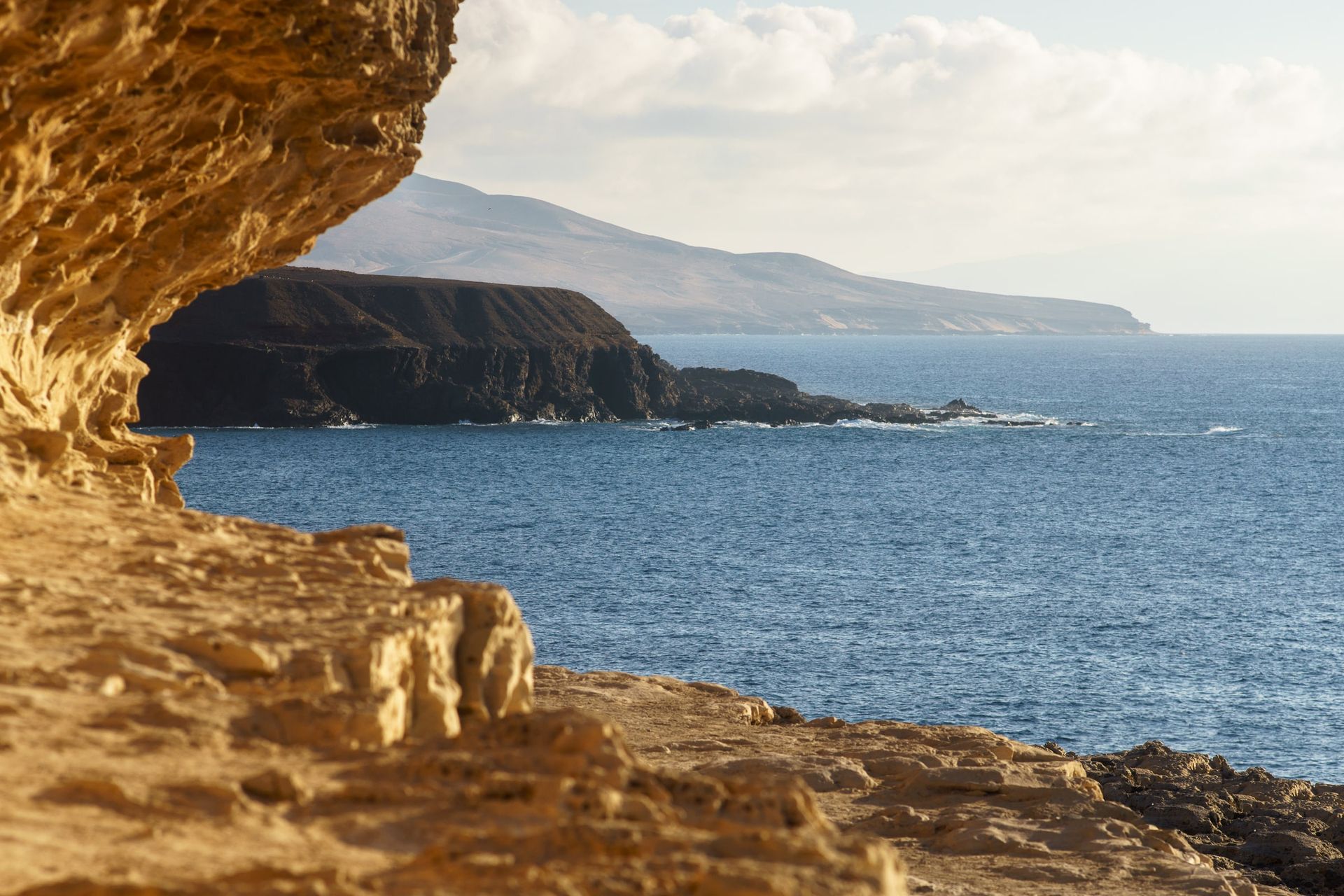 Rock arch in the cliffs of Fuerteventura overlooking the sea